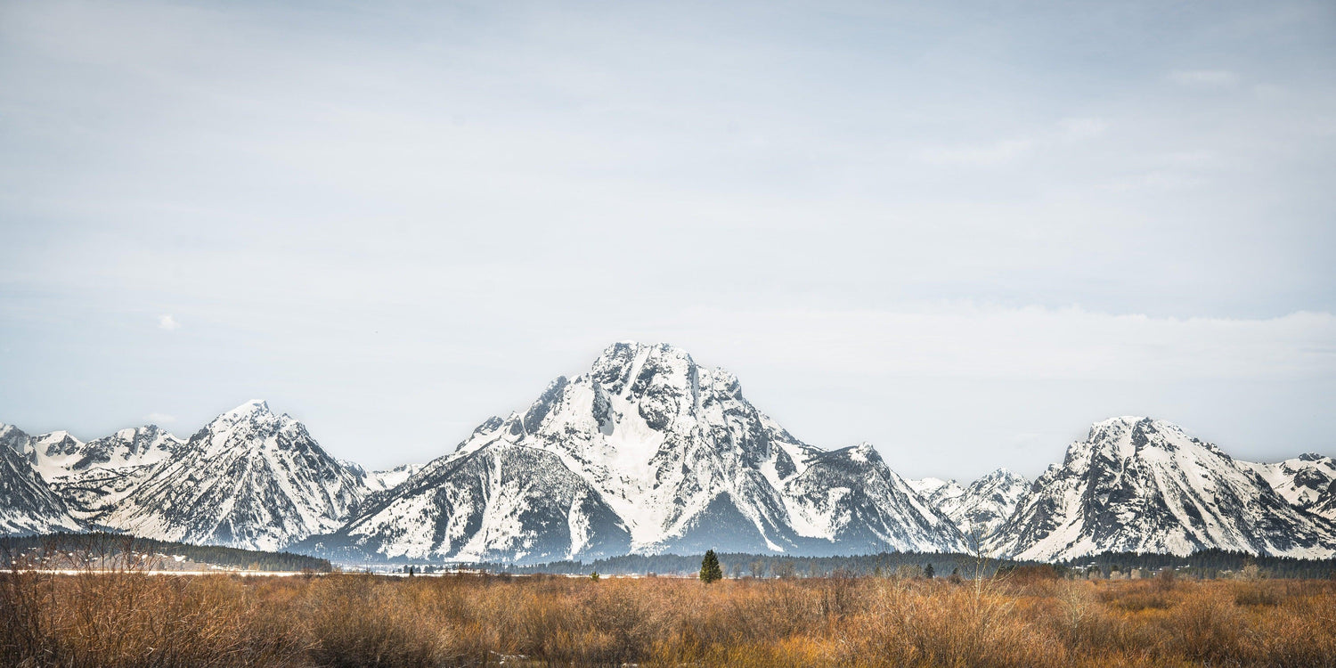 Fine Grand Teton National Park photography print of vast expanse of the Grand Teton mountain range covered in snow.