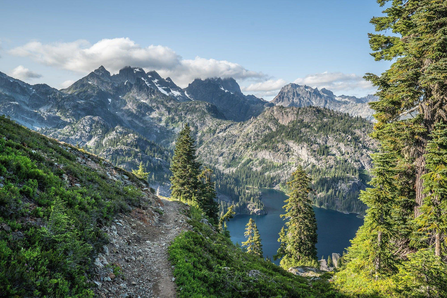 Fine Pacific Crest Trail photography print of a high-alpine portion of the PCT as it ascends through Washington State with a view of a large lake and mountain range.