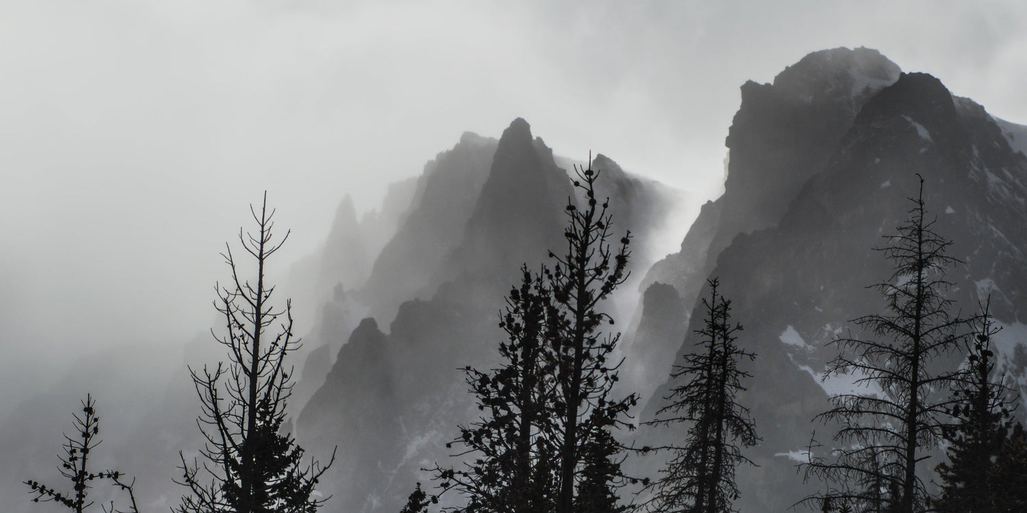 Fine Rocky Mountains National Park photography print of a misty layer covering the mysterious mountain peaks.