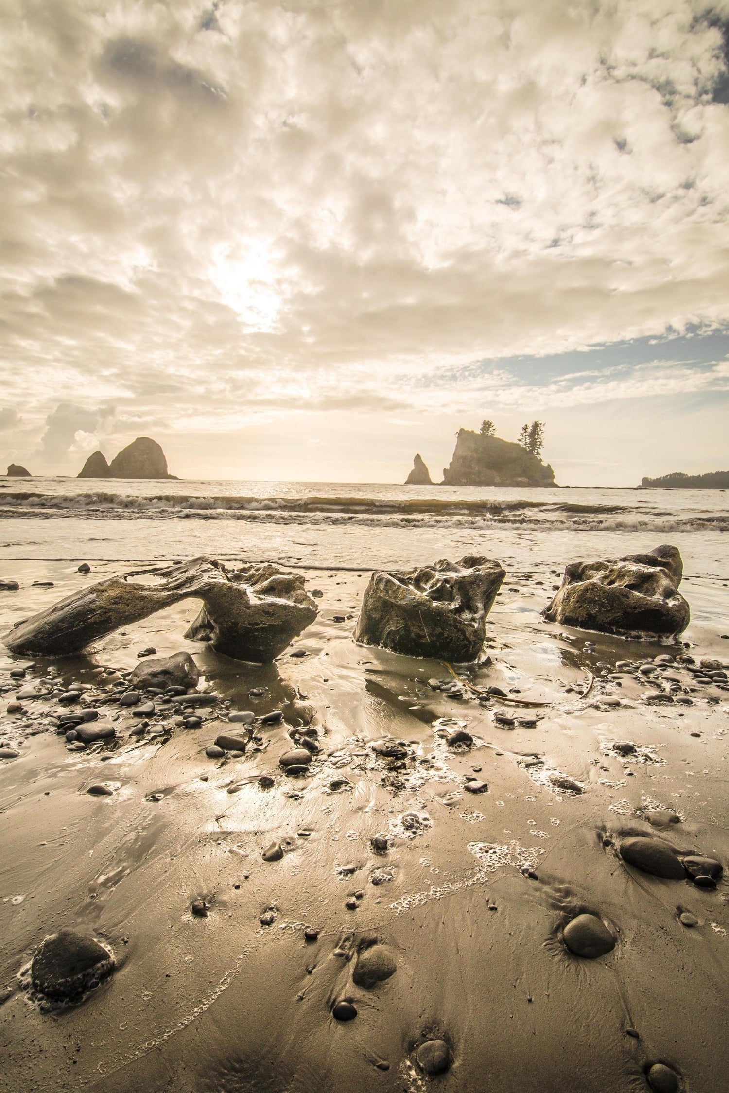 Fine photographic print of the sun setting on the rocky beaches of Olympic National Park.