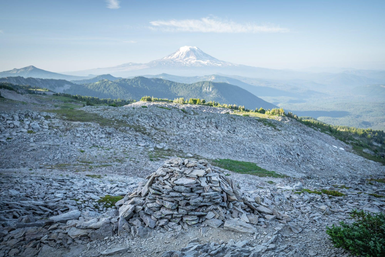 Fine Pacific Crest Trail photography print of a pile of stones off the side of the Goat Rocks area and the volcano in the background.
