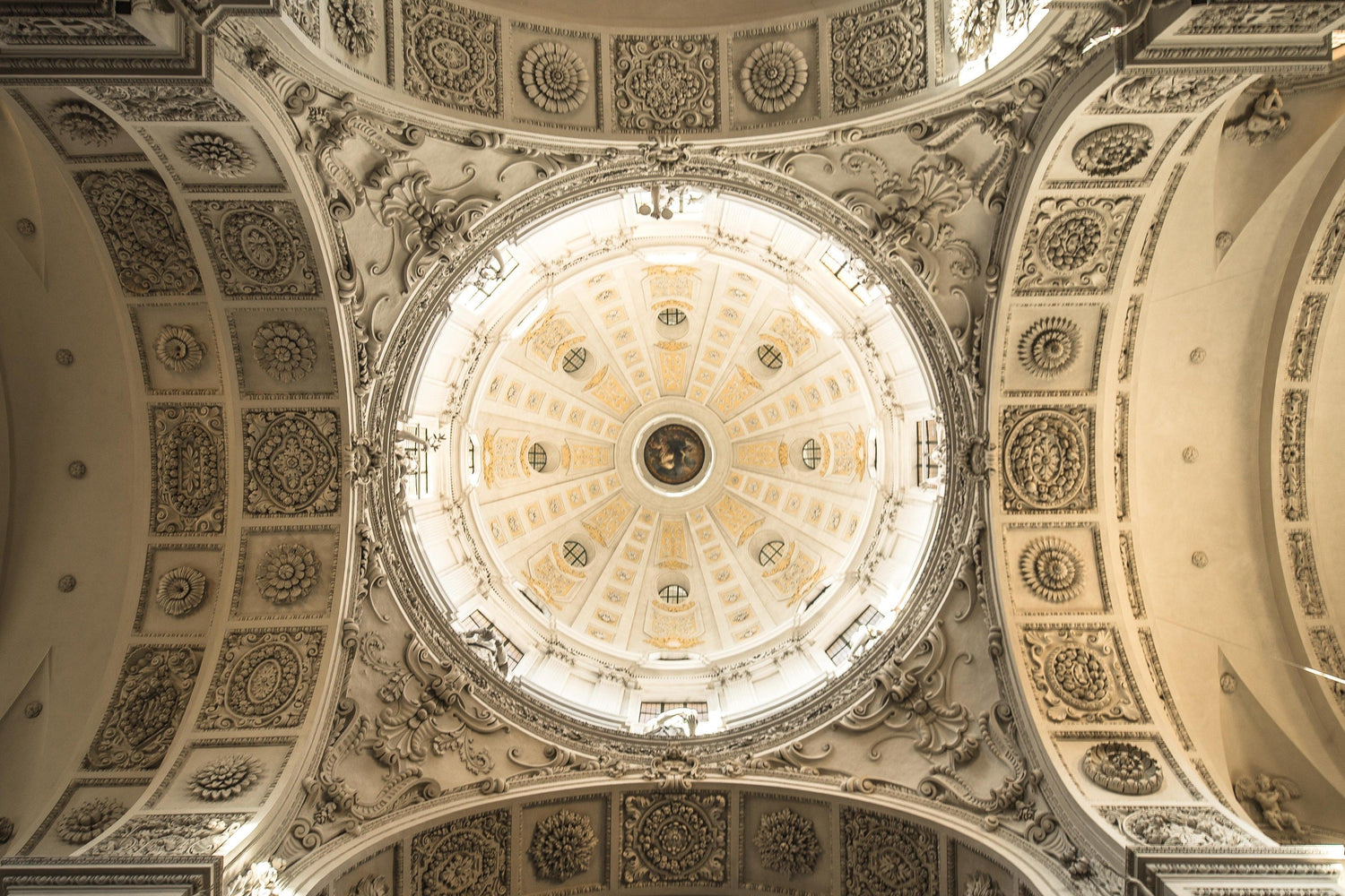 Fine photography print of the well-illuminated and ornately carved decorated dome of the Theatine Church in Munich Germany.