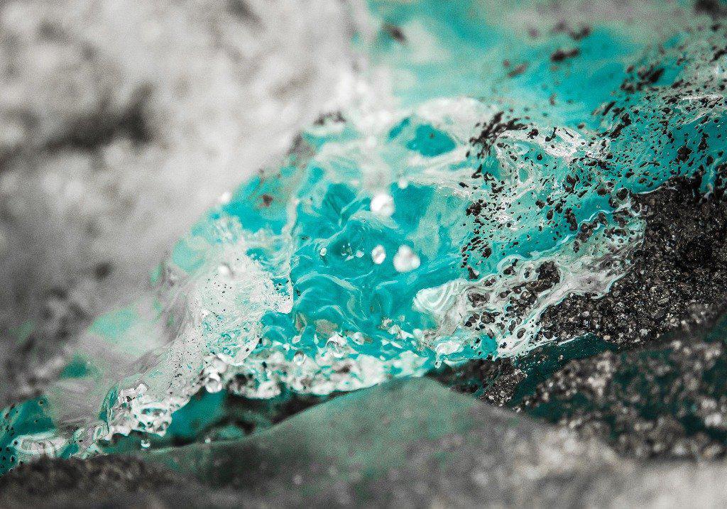 Fine photographic and art print of bright blue water melting off a glacier in Wrangell St Elias National Park in Alaska.