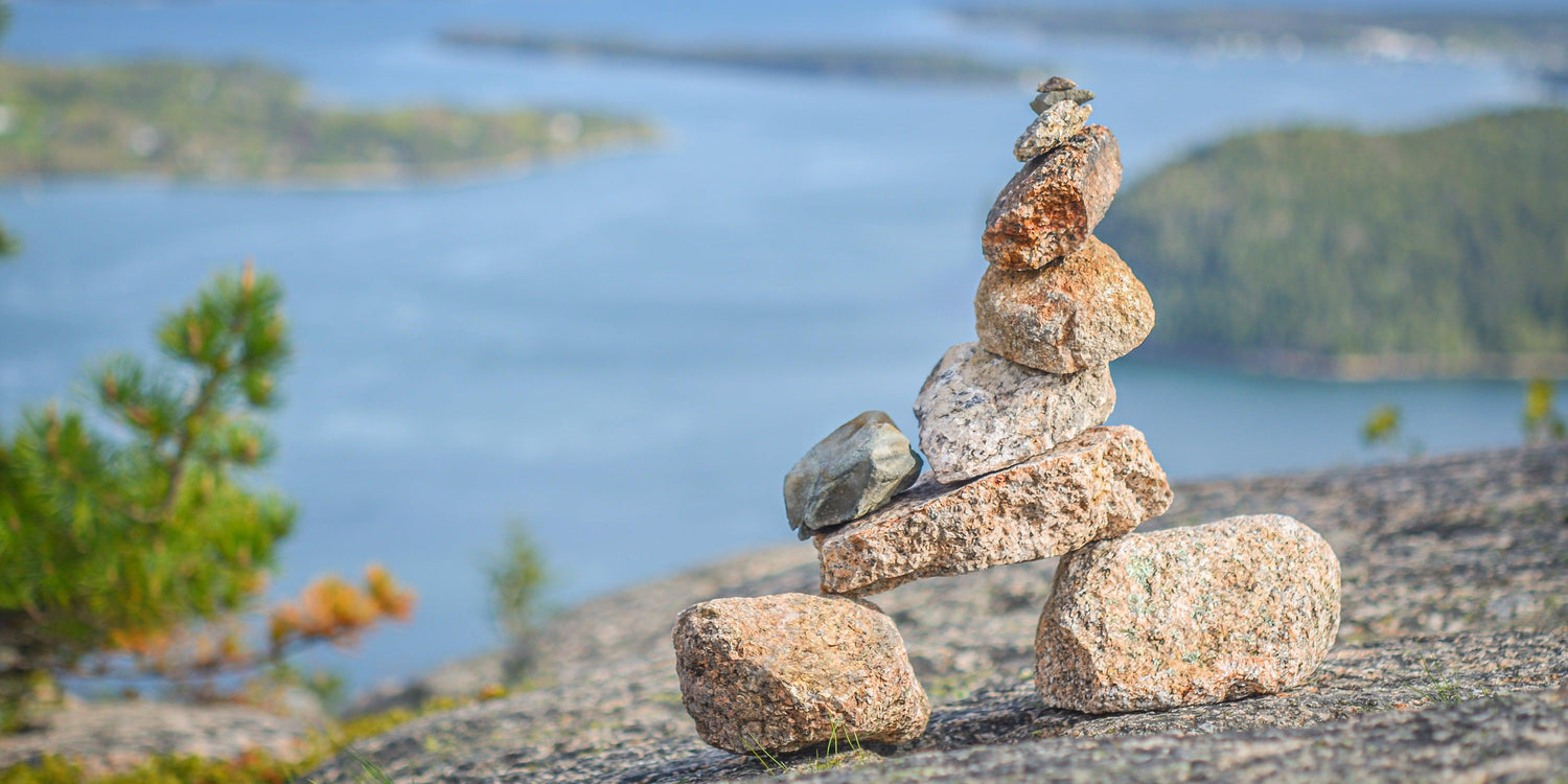 Fine photographic print of a rock cairn in the foreground of the waterways of Acadia National Park in Maine.
