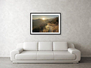 Framed fine photographic and wall art print of a sunrise highlighting the desert trail of the Pacific Crest Trail with mountains in the background.