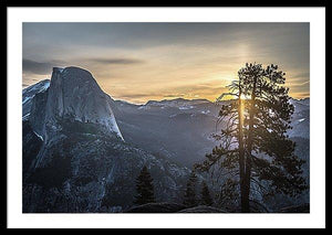 Framed fine photographic and art print of sunrise at Glacier Point in Yosemite National Park in California with Half Dome in the near distance and a tree in the foreground.