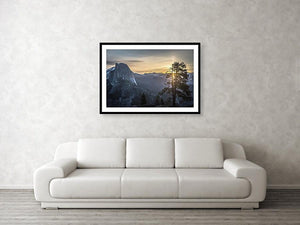 Framed fine photographic and wall art print of sunrise at Glacier Point in Yosemite National Park in California with Half Dome in the near distance and a tree in the foreground.