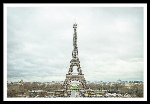Framed fine photographic and art print of the Eiffel Tower in the distance with a cloudy backdrop over the landscape of Paris France. 