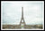 Framed fine photographic and art print of the Eiffel Tower in the distance with a cloudy backdrop over the landscape of Paris France. 