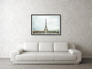 Framed fine photographic and wall art print of the Eiffel Tower in the distance with a cloudy backdrop over the landscape of Paris France. 