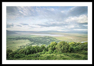 Framed fine Ngorongoro Crater photography print of the expansive crater atop the rim as the clouds breach the crater, casting shadows on the luscious landscape.