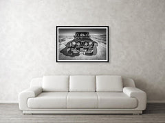 Framed fine black and white photographic and wall art print of a black Jeep Wrangler off-road driving along the White Rim Trail of Canyonlands National Park near Moab, Utah.