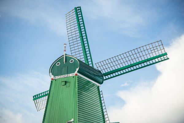 Fine photographic and art print of a single green windmill against a backdrop of blue dutch skies.