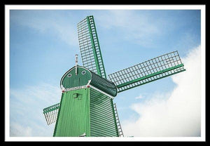 Framed fine photographic and art print of a single green windmill against a backdrop of blue dutch skies.